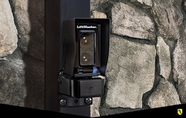 A LiftMaster Photo Eye installed on post with illuminated blue light (unobstructed).
